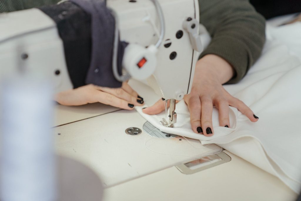 person in white shirt sewing